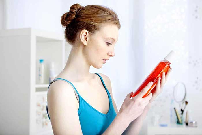 A girl holding mouth washer in her hand