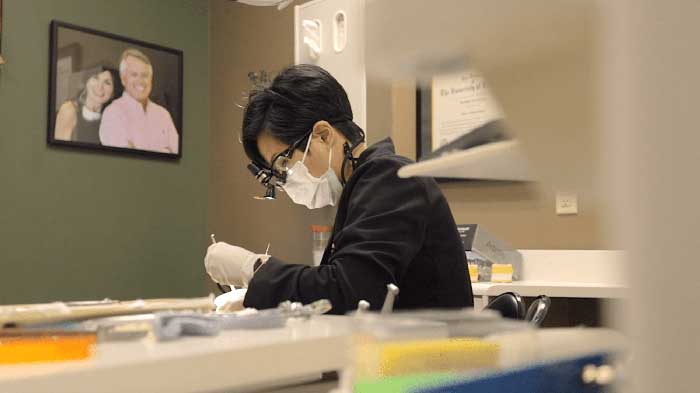 A boy checking through microscope