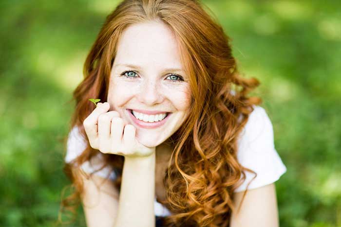 A girl smiling in glass