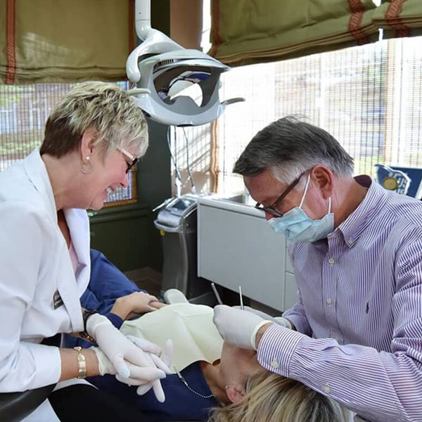 dentist and dental assistant with patient