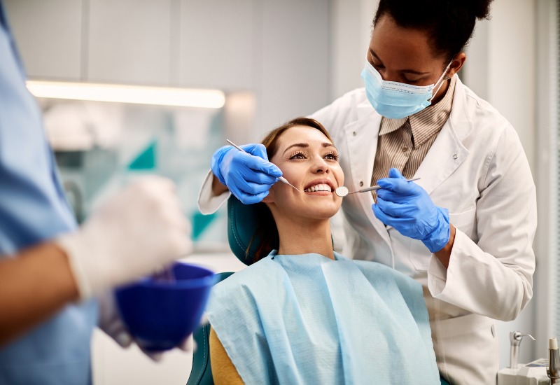 Socket preservation is shown during a dental exam by a dentist after tooth extraction in Germantown