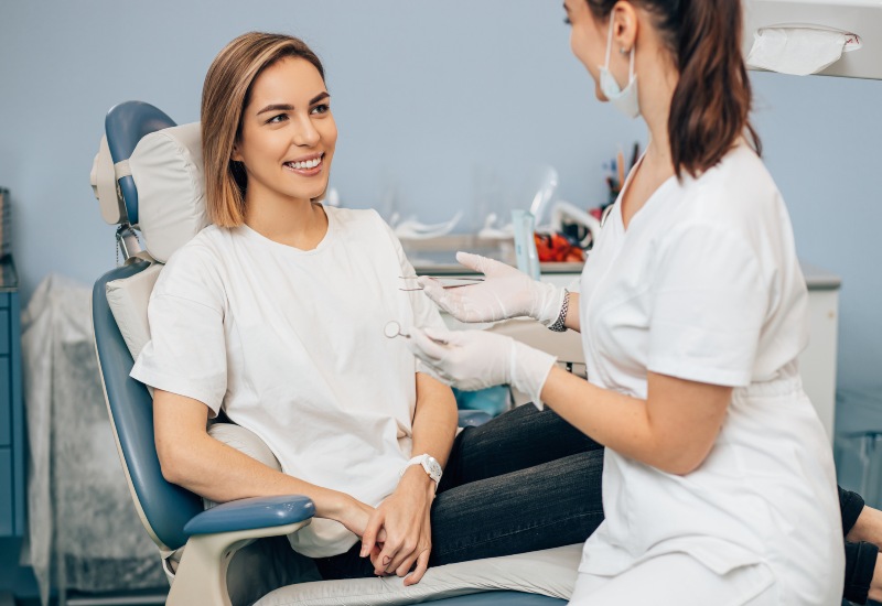 A patient & dentist smiling in a clinic showing the benefits of General Dentistry in Germantown, TN