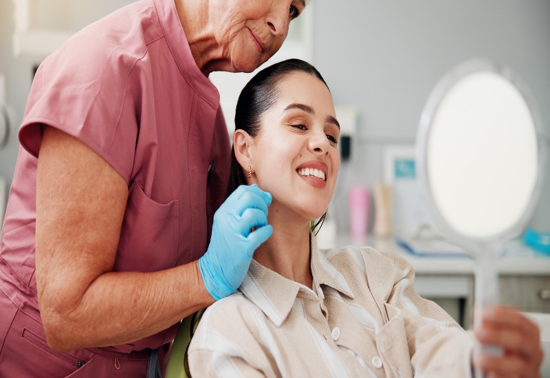 A patient reviewing results in a dental clinic after a cosmetic dental procedure in Germantown, TN