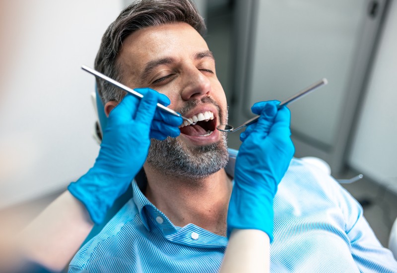 A dentist performing restorative dental treatment on a patient at a dental clinic in Germantown, TN