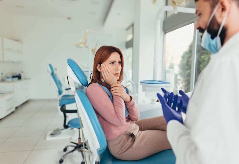 A dentist explaining the possible complications to a patient at a clinic in Germantown, TN