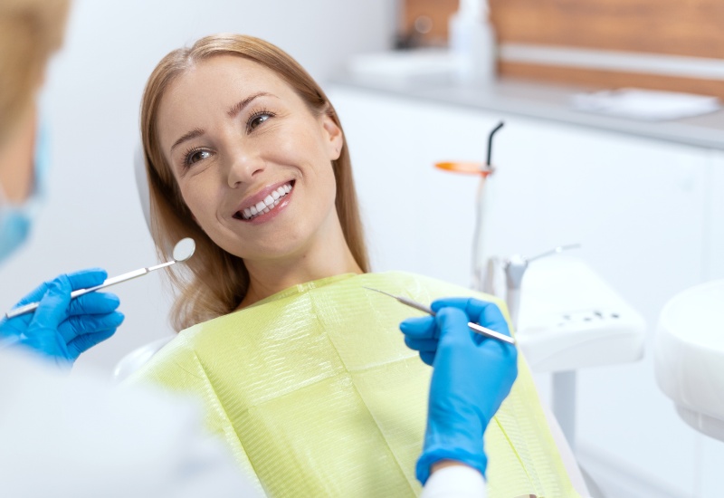 A patient smiling during a teeth cleaning procedure at a dental clinic in Germantown, TN