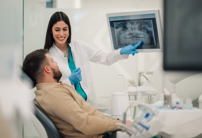 Dentist reviewing dental X-ray with patient using advanced dental technology in Germantown, TN
